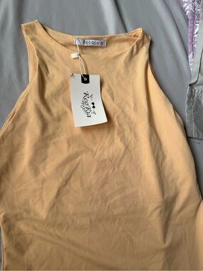 Reoria Sleeveless Peplum Bodysuit in Beige